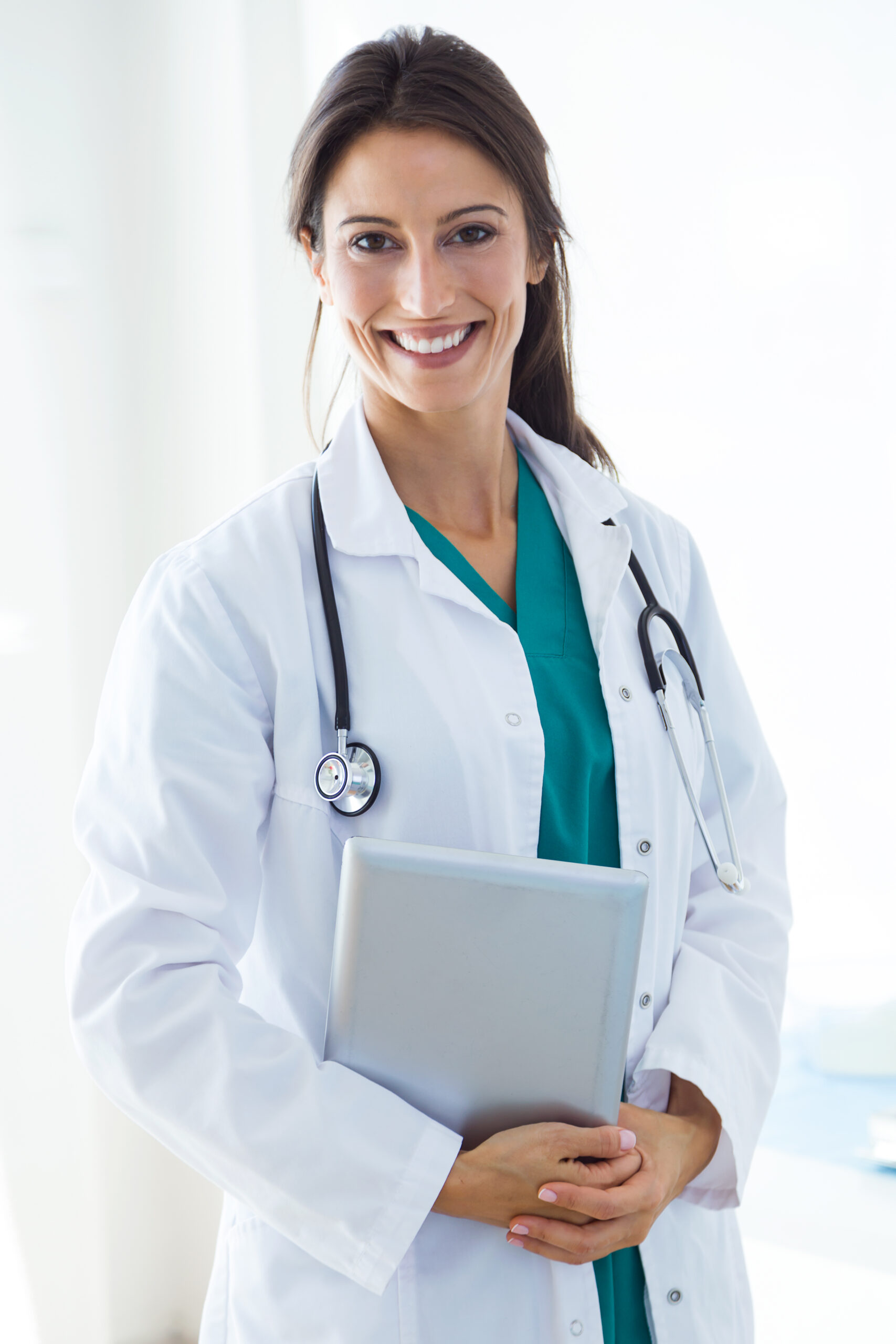 Beautiful young female doctor looking at camera in the office - Evolve Your Success